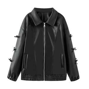 Detail of black PU leather jacket featuring bow accents on sleeves and a zipped front