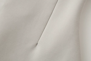 Close-up detail of beige twill fabric texture and high-quality stitching on the tube top