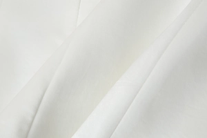 Close-up of white Y2K tube top fabric showing detailed fine texture and soft pleats