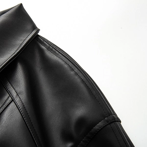 Detail of premium black PU leather jacket with textured grain and neat double stitching