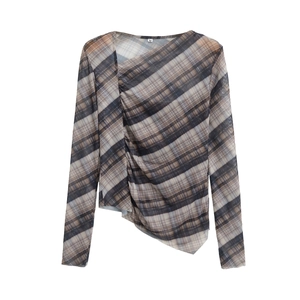 Detail view of ruched mesh long sleeve top featuring diagonal plaid pattern and asymmetric hem