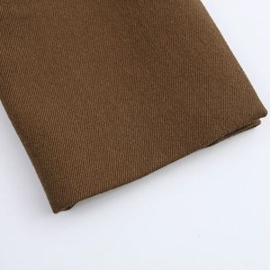 Close-up detail of the coffee brown thick twill fabric texture for women's blazer jacket