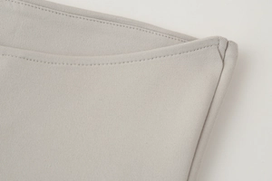 Macro detail of high-density knitted fabric and double stitching on light grey Y2K tube top