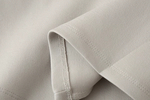 Close-up of high-quality sewing stitches and knit fabric texture on Y2K tube top