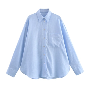 Détail d'une chemise en lin bleu clair montrant le col à revers et la texture du tissu