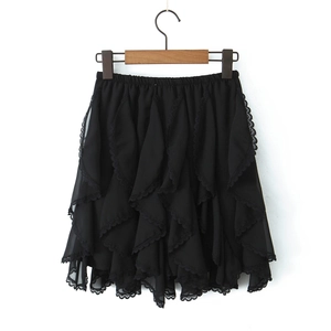 Close-up of black ruffled mini skirt with layered lace hem on wooden hanger