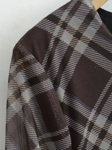 Détail du tissu en maille transparente à carreaux marron vintage avec coutures fines