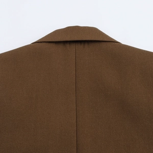 Close-up detail of the brown blazer collar and rear stitching in twill fabric