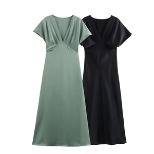 Detailed view of elegant satin midi dresses with V-neckline in green and black colors