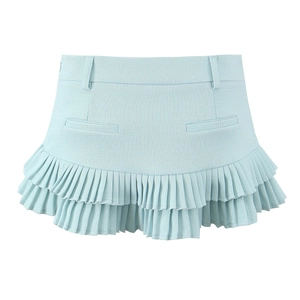 Detail of light blue pleated mini skirt showing premium tweed texture and ruffle hemline