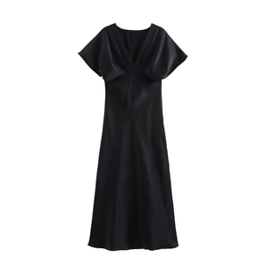 Close-up of elegant V-neckline and smooth satin fabric on a black midi dress