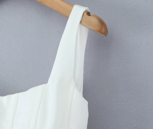 Detailed view of white dress square neck with corset boning structure and wide straps