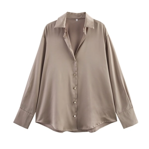 Detail of satin shirt showing glossy champagne fabric texture and classic button collar