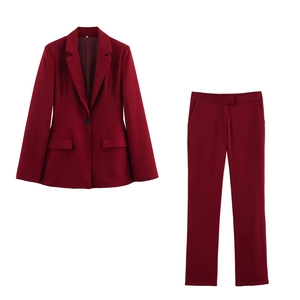 Detail view of burgundy two-piece suit set with lapel blazer and straight-leg trousers