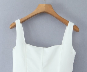 Detail view of white square-neck dress with corset-style fishbone stitching and wide straps