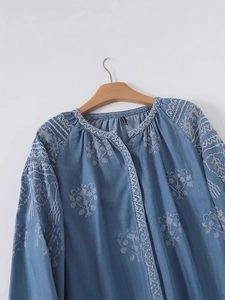 Light blue denim blouse with white floral embroidery and casual loose long sleeves