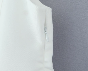 Detail of side invisible zipper on white square neck dress with smooth fabric texture