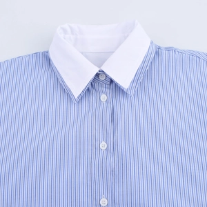 Detail of the blue white striped shirt featuring a white collar and button closure