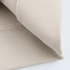 Detail shot of beige fabric showing high-quality stitching and overlock hem workmanship