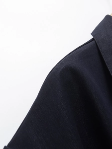 Close-up of the shoulder structure and textured fabric on denim dress