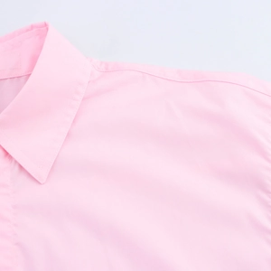 Detail view of the pink short-sleeve shirt showing the sharp collar and shoulder stitching