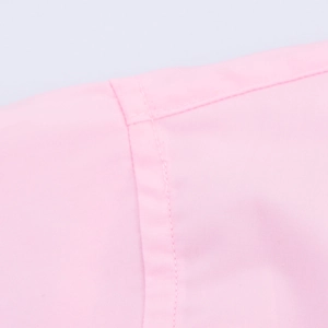 Close-up of pink short sleeve shirt showing clean shoulder stitching and cotton fabric