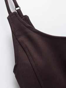 Detail of adjustable spaghetti strap and fine stitching on a brown ruched dress