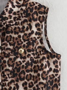 Detail of leopard print vest featuring a flap pocket with a gold embossed button