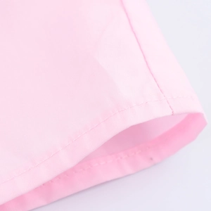 Detail of pink cotton shirt featuring clean double-needle stitching and fabric texture
