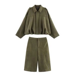 Detailed flat lay of olive green suede cropped aviator jacket and wide-leg shorts set