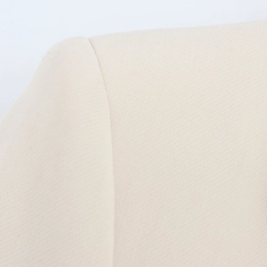 Detailed macro view showing professional stitching and woven texture of the beige blazer suit
