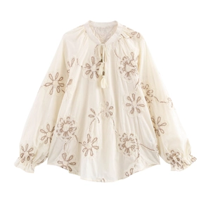 Detailed embroidery on cream long sleeve shirt with frilled cuffs and tassel collar