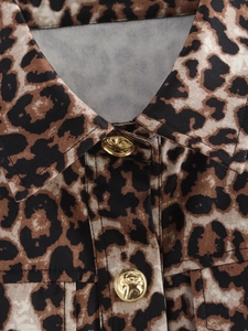 Detail of leopard print vest featuring premium gold buttons and a classic turnover collar
