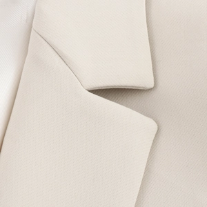 Detailed view of the lapel and premium textured fabric of the beige women blazer suit