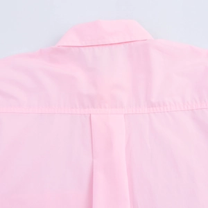 Detail of pink French blouse back yoke and central pleat showing high-quality stitching