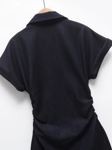 Detail of ruched waist and turn-down collar on a dark blue denim short sleeve dress
