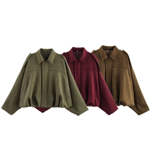 Detail of army green, burgundy, and tan cropped jackets with epaulettes and pleated hems
