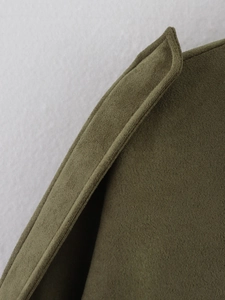 Macro shot of army green suede jacket collar showing premium stitching and texture