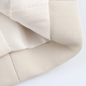 Detailed close-up showing beige woven fabric texture and smooth twill lining of suit