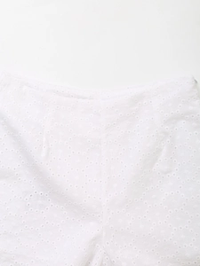 Detailed close-up of white eyelet embroidery and hollowed-out floral pattern on the waist