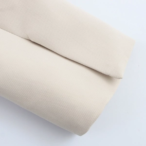 Detailed close-up of beige twill woven fabric for women's two-piece suit set texture