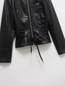 Detail of PU leather jacket with golden zipper and waist tie featuring metal aglets