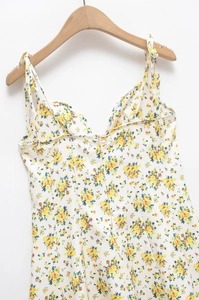 Close-up of floral print V-neck dress with yellow and blue flowers on white fabric