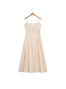 Sleeveless smocked maxi dress in cream white with slim straps and A-line silhouette