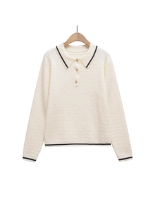 Chic cream knit polo sweater with black contrast trim and decorative gold buttons