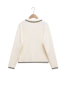 Back view of minimalist cream knit polo sweater with black contrast trim on collar and cuffs