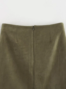 Detail van een olijfgroene suède rok met een onzichtbare ritssluiting aan de achterkant
