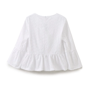 Detailed macro shot of white eyelet embroidery and hollow out cotton fabric on women's top