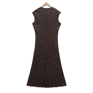 Detail view of deep brown sleeveless maxi dress featuring a unique pleated crinkled texture