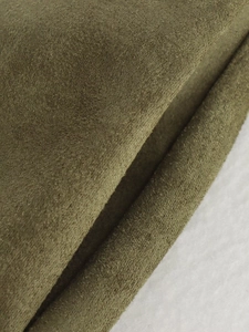 Close-up of olive green suede fabric showing brushed texture and thick material quality